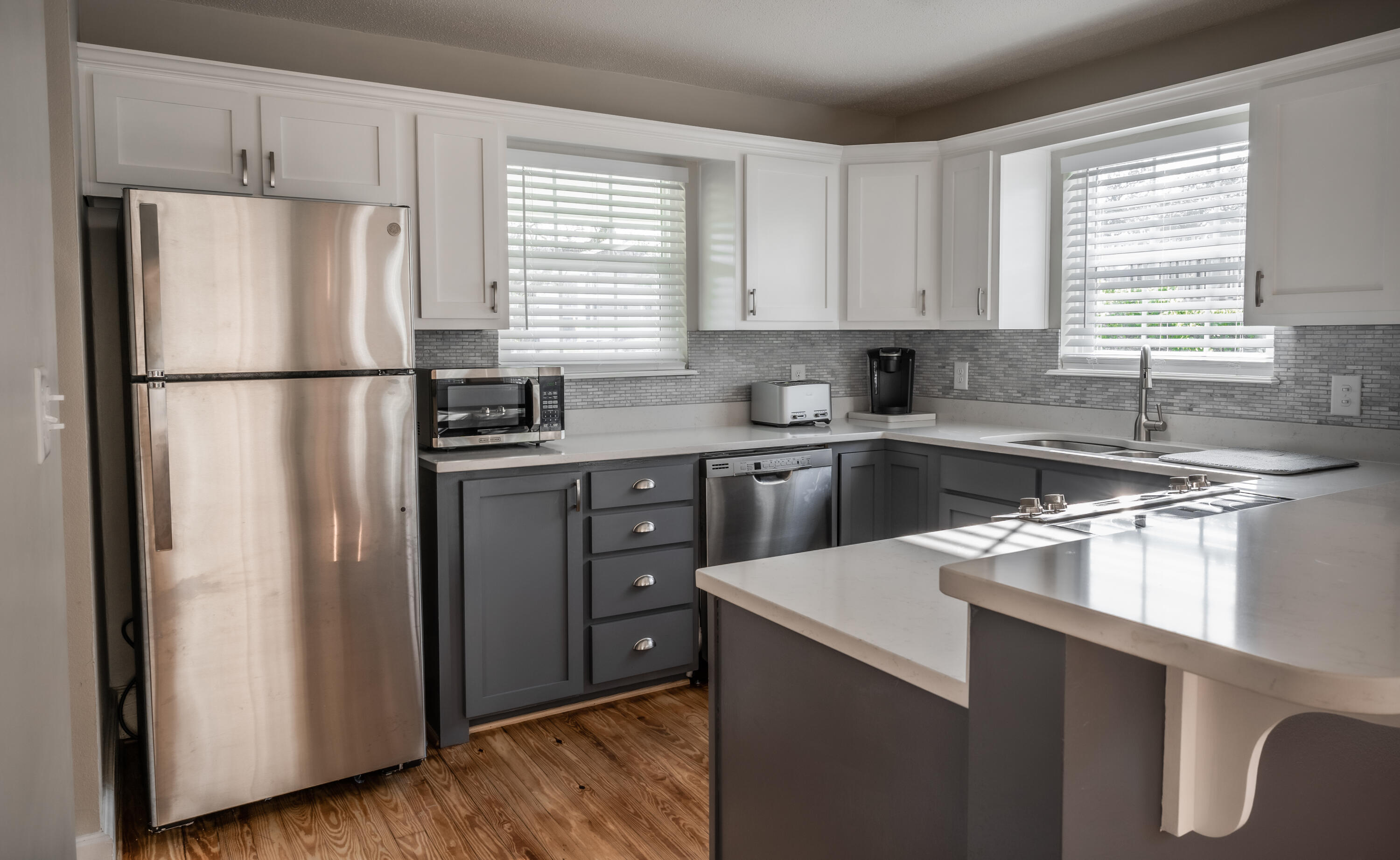 8103 East County Highway 30A Inlet Beach, FL 32461 - Photo 13 of 46 a kitchen with stainless steel appliances a refrigerator sink and cabinets