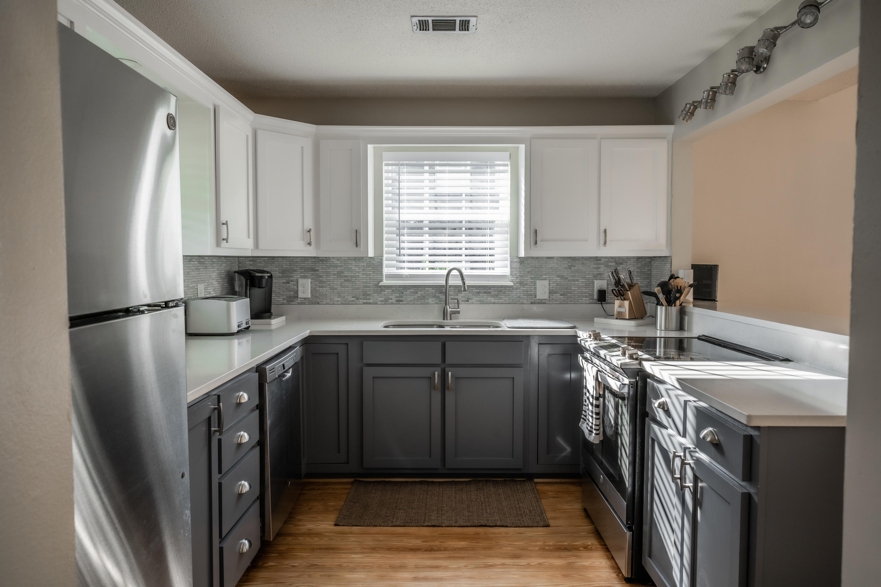 8103 East County Highway 30A Inlet Beach, FL 32461 - Photo 14 of 46 a kitchen with stainless steel appliances granite countertop a sink stove and a refrigerator