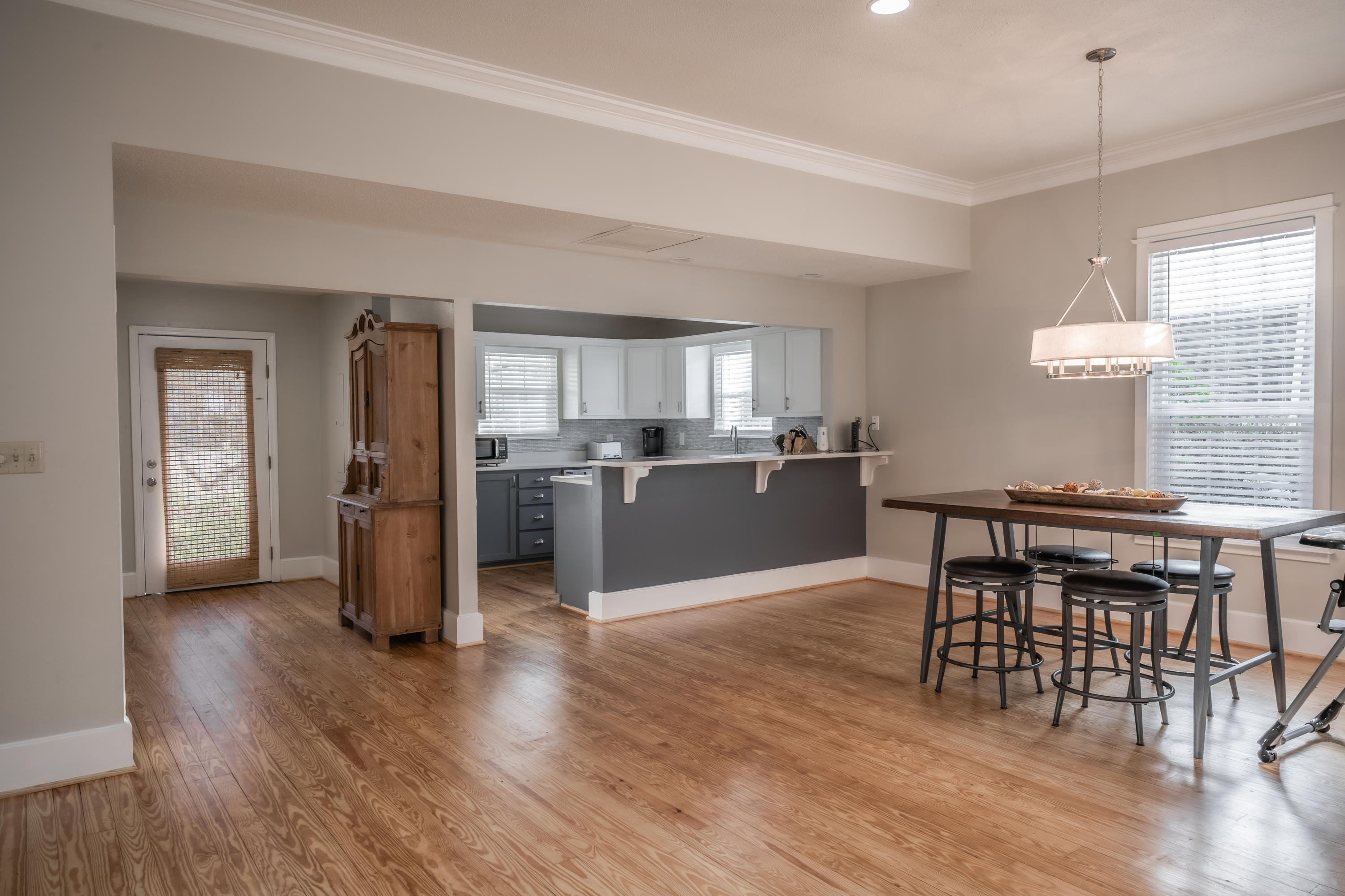 8103 East County Highway 30A Inlet Beach, FL 32461 - Photo 9 of 46 a kitchen with stainless steel appliances wooden floor dining table and chairs