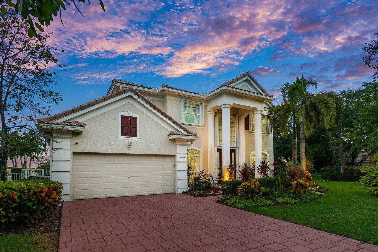 10290 Northwest 60th Place Parkland, FL 33076 - Photo 14 of 36 a front view of a house with a garden