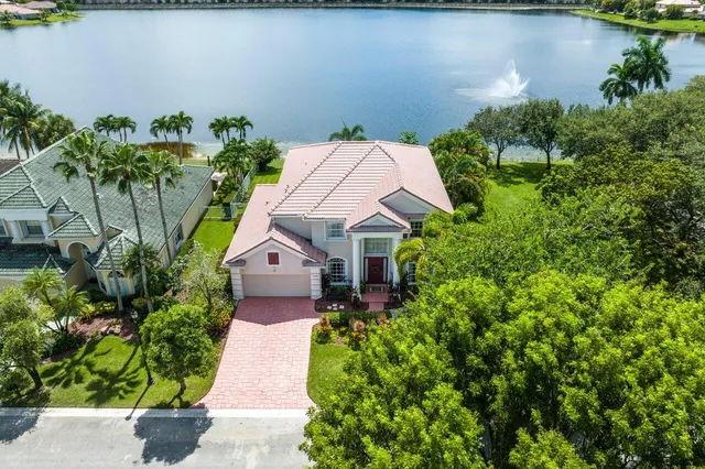 an aerial view of house with yard and outdoor seating