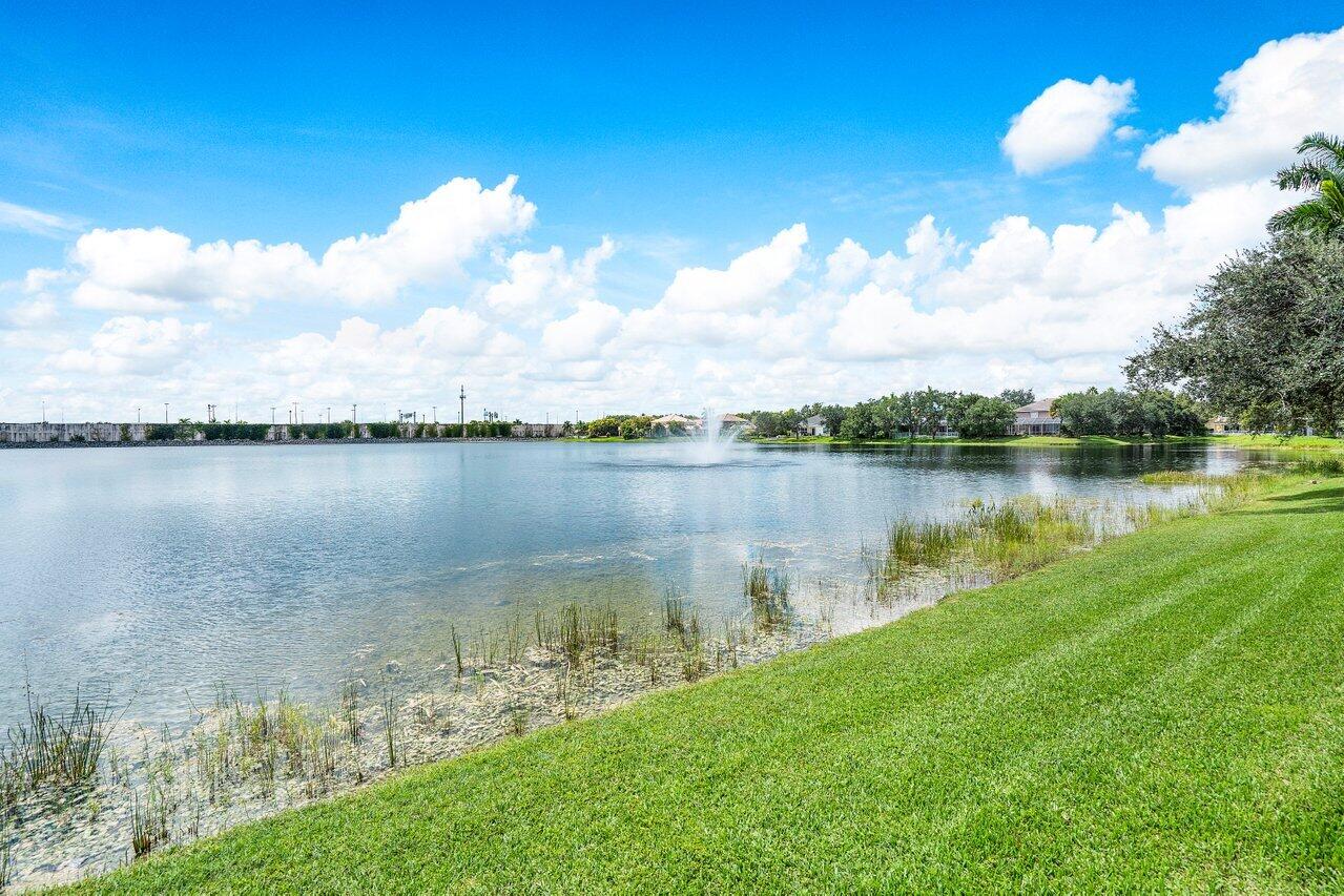 10290 Northwest 60th Place Parkland, FL 33076 - Photo 26 of 36 a view of a lake with houses in the back