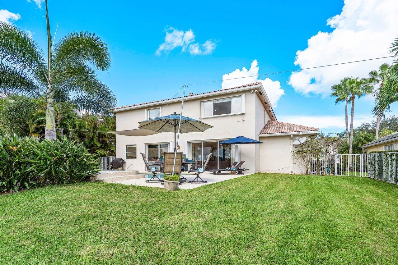 10290 Northwest 60th Place Parkland, FL 33076 - Photo 29 of 36 a view of a patio with table and chairs potted plants and large tree