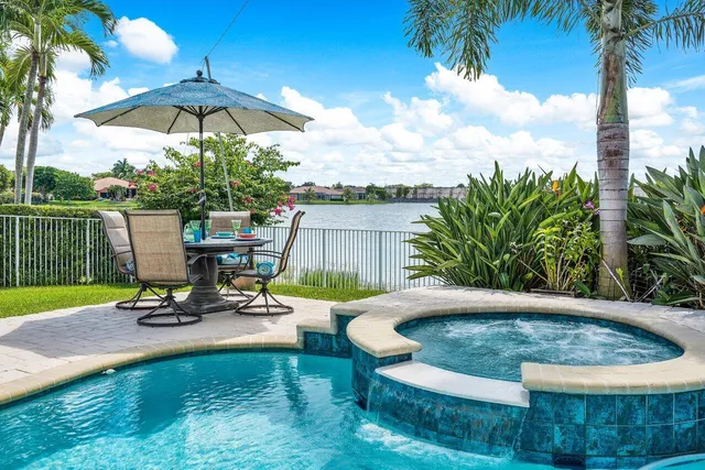 a view of a swimming pool with a patio and a garden