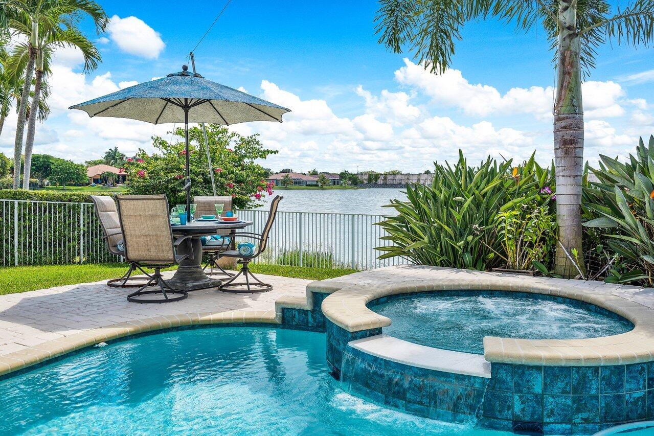 10290 Northwest 60th Place Parkland, FL 33076 - Photo 30 of 36 a view of a swimming pool with a patio and a garden