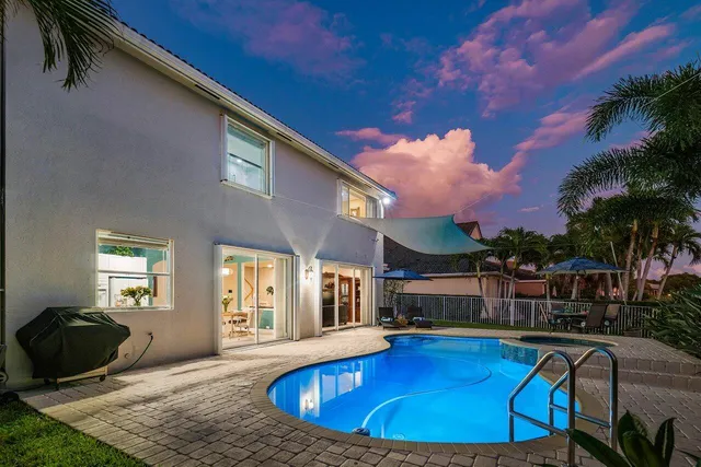 a view of a house with swimming pool and sitting area