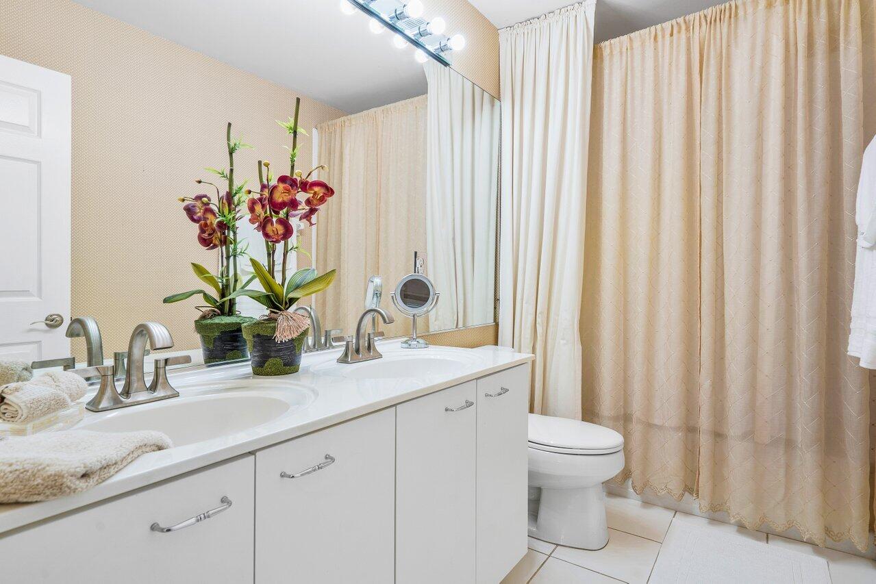 10290 Northwest 60th Place Parkland, FL 33076 - Photo 36 of 36 a bathroom with a sink a toilet and a mirror