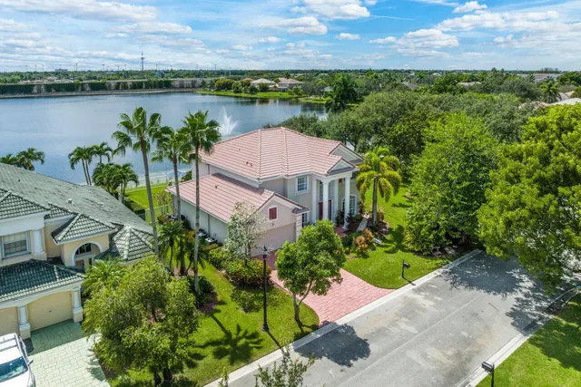 an aerial view of a house with garden space and a lake view