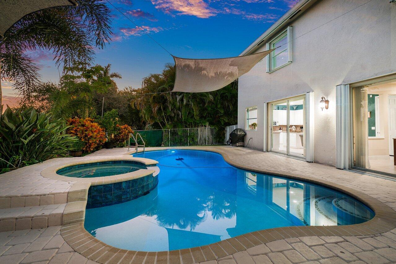 10290 Northwest 60th Place Parkland, FL 33076 - Photo 6 of 36 a view of a swimming pool with an outdoor seating and a yard
