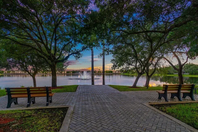 a park view with a bench in a garden