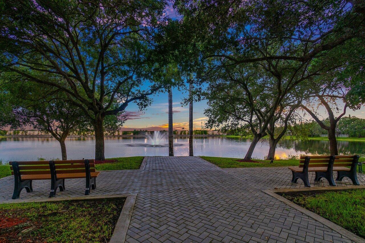 10290 Northwest 60th Place Parkland, FL 33076 - Photo 8 of 36 a park view with a bench in a garden