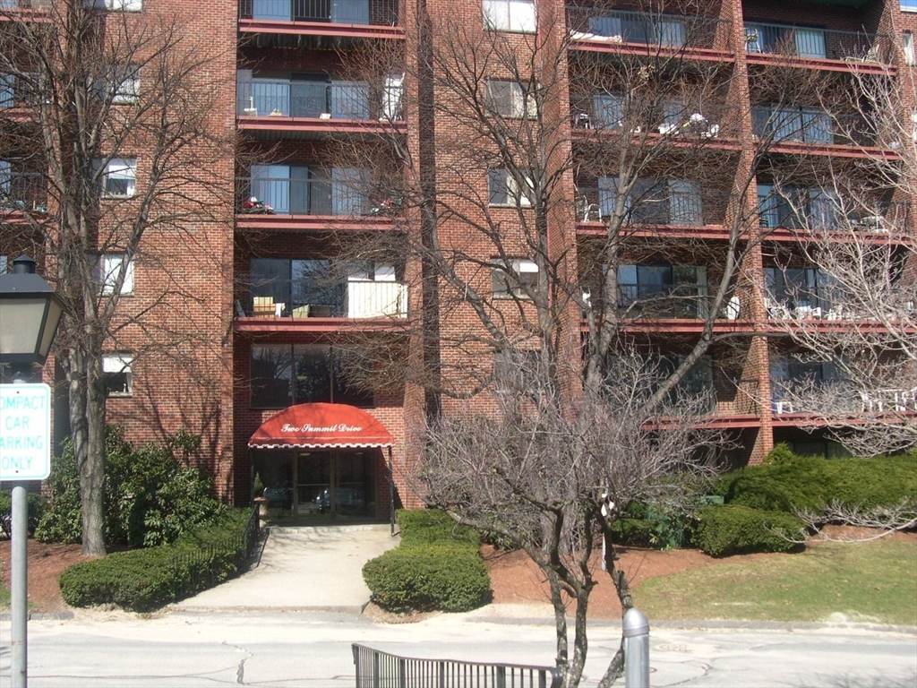 2 Summit Drive, Unit 18 Wakefield, MA 01880 - Photo 1 of 11 a front view of a residential apartment building with a yard