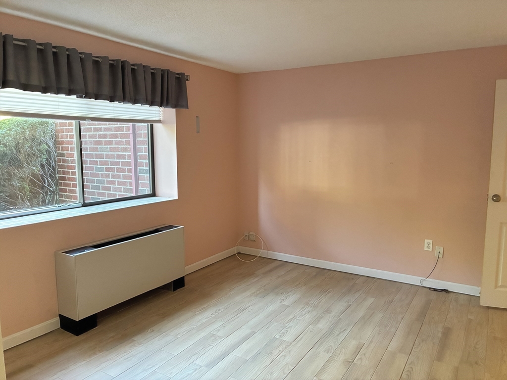 2 Summit Drive, Unit 18 Wakefield, MA 01880 - Photo 3 of 11 a view of a room with wooden floor and small window