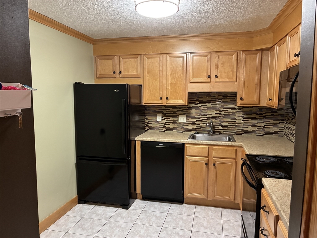 2 Summit Drive, Unit 18 Wakefield, MA 01880 - Photo 5 of 11 a kitchen with a refrigerator and a sink