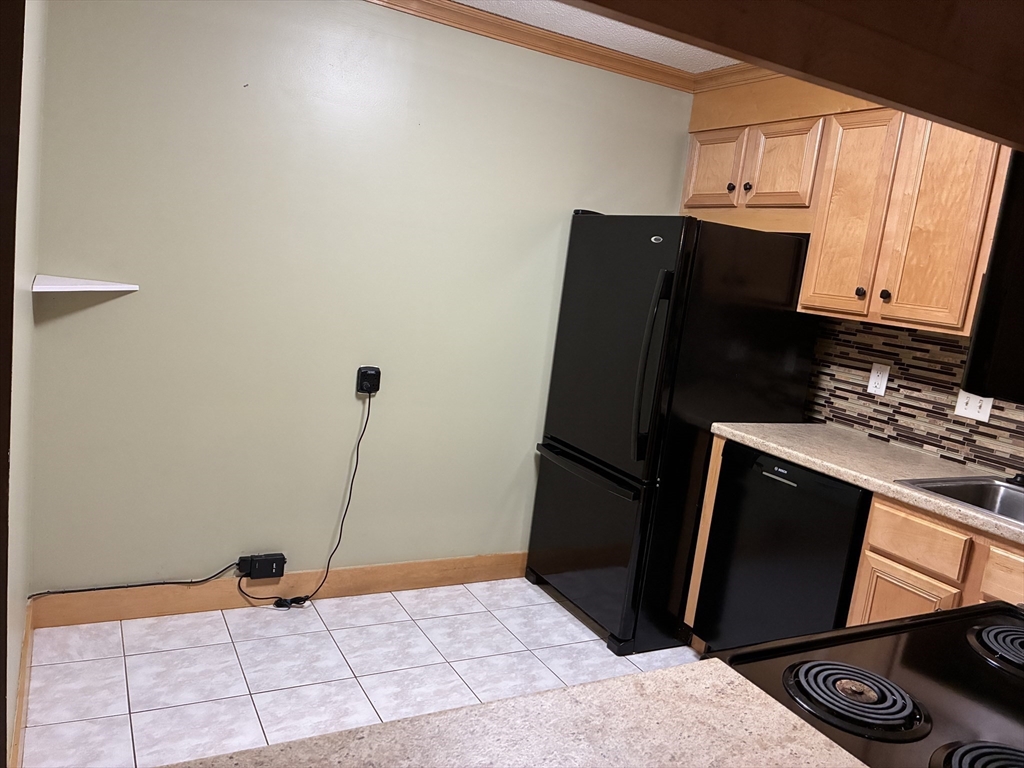 2 Summit Drive, Unit 18 Wakefield, MA 01880 - Photo 6 of 11 a view of a refrigerator and window