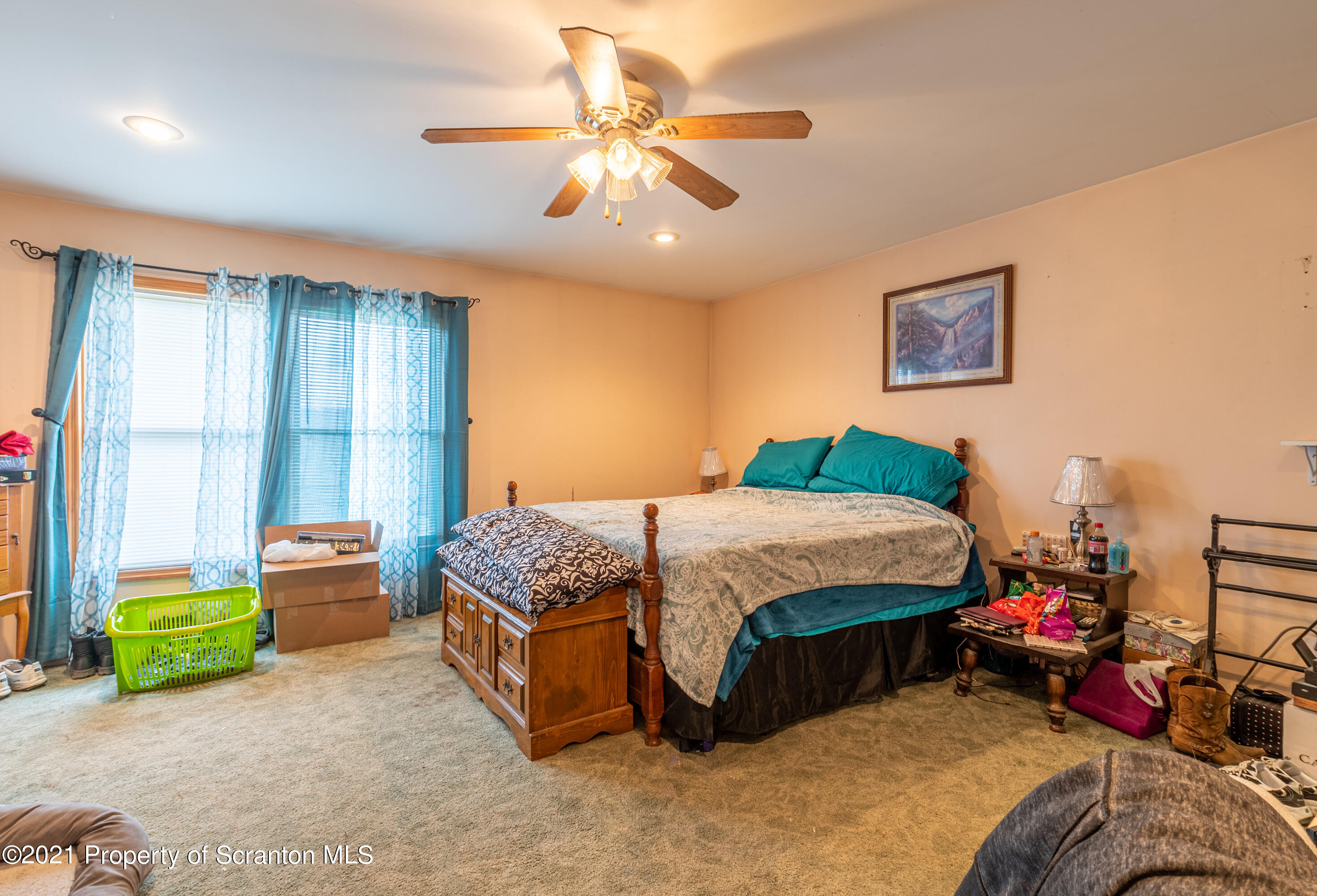 172 Potter Road Kingsley, PA 18826 - Photo 24 of 56 a spacious bedroom with a bed and a chandelier
