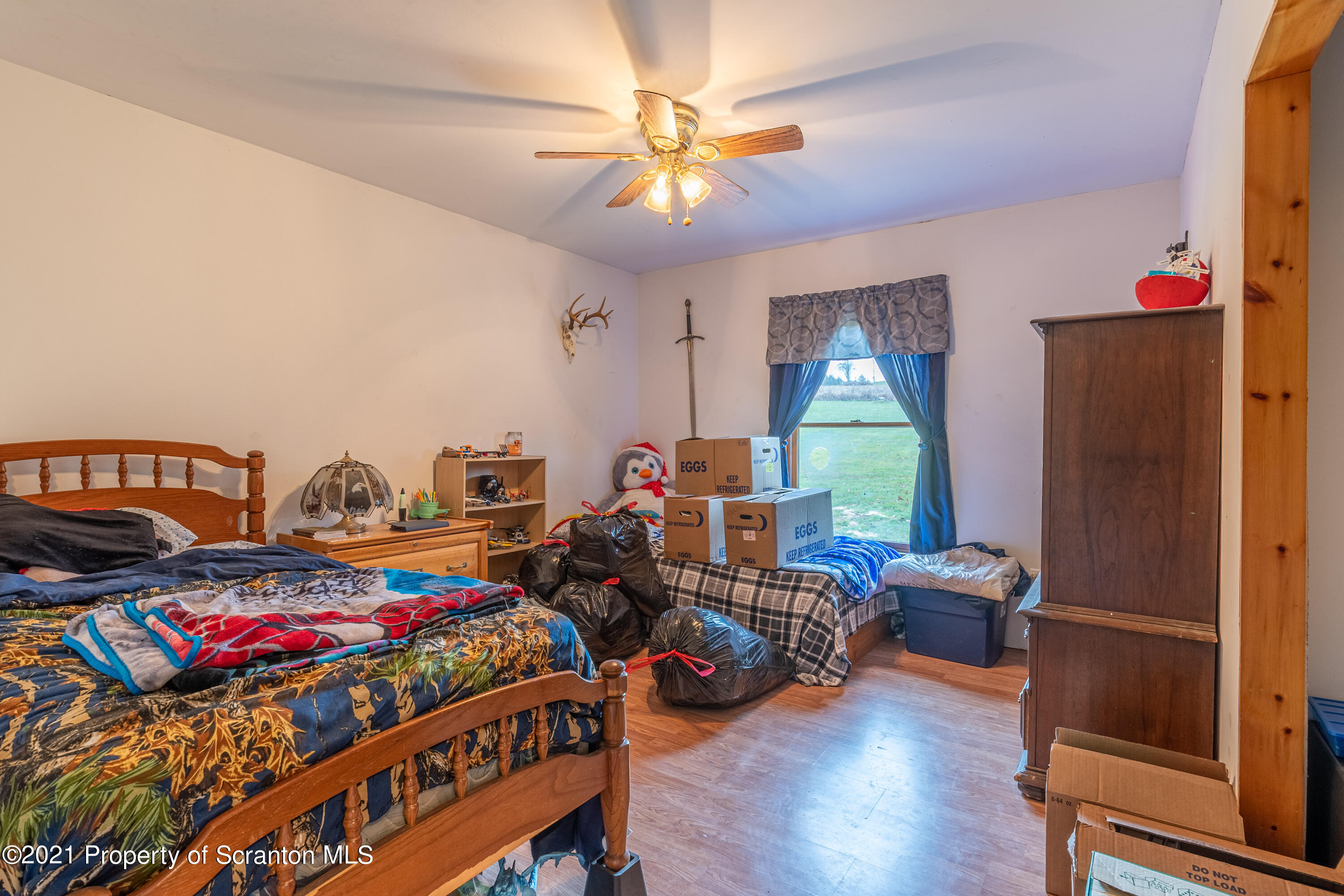 172 Potter Road Kingsley, PA 18826 - Photo 29 of 56 a bedroom with bed and a chandelier