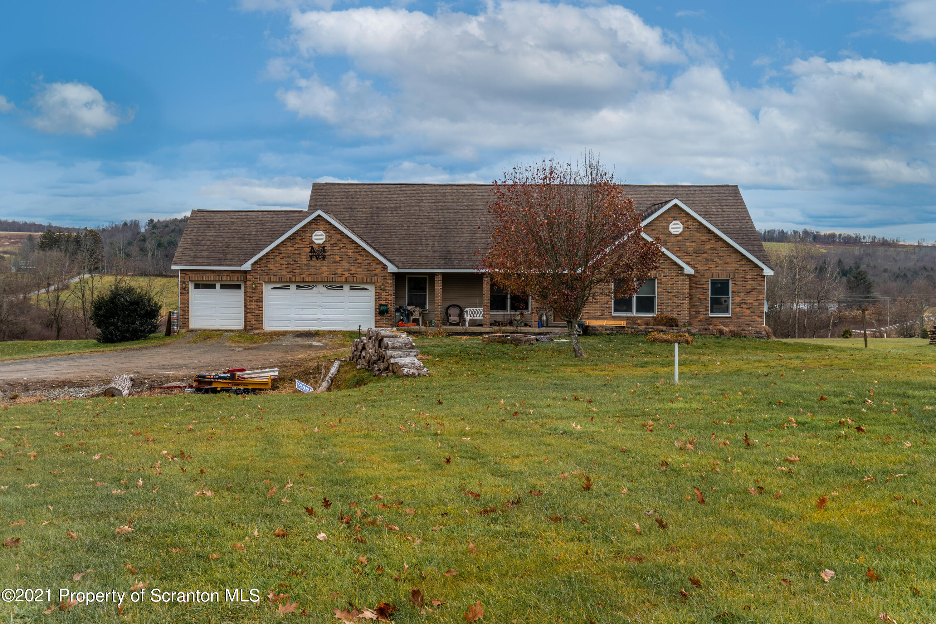 172 Potter Road Kingsley, PA 18826 - Photo 3 of 56 a front view of a house with a yard