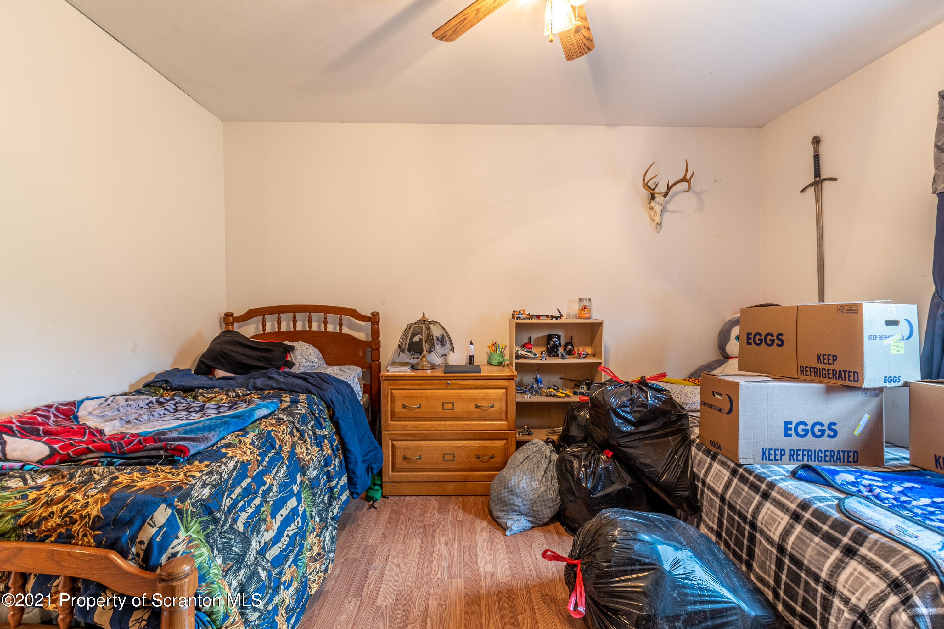 172 Potter Road Kingsley, PA 18826 - Photo 32 of 56 a bedroom with a bed and wooden floor