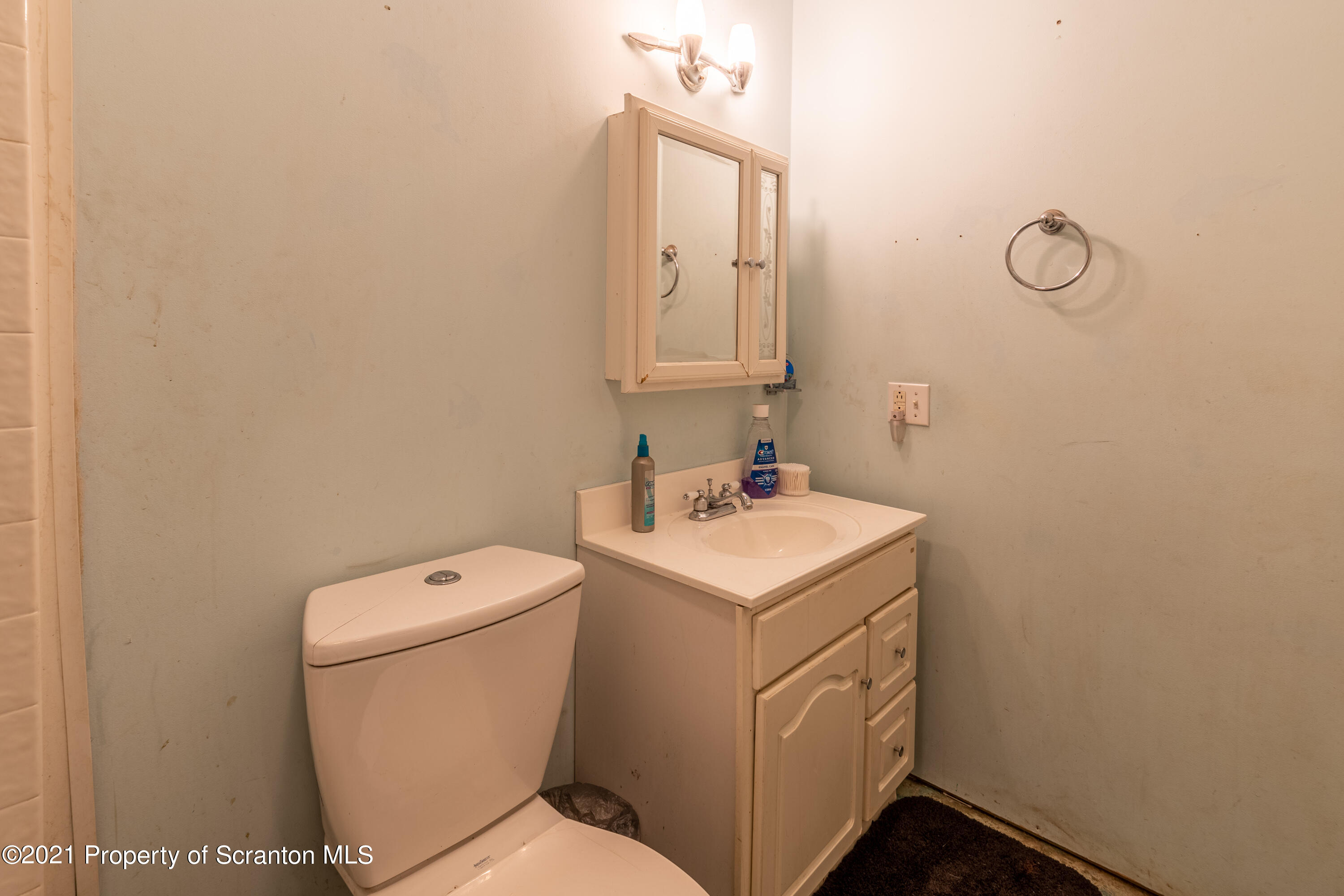172 Potter Road Kingsley, PA 18826 - Photo 40 of 56 a bathroom with a toilet sink and mirror