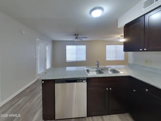 a kitchen with a sink and a mirror