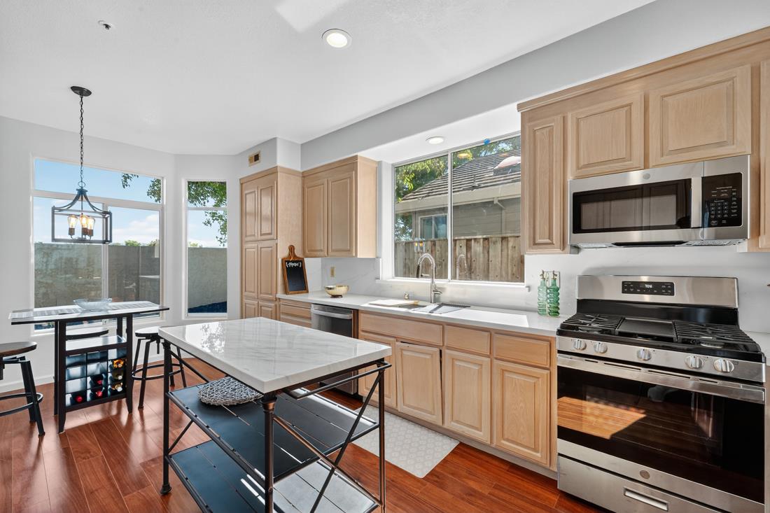 17671 Riverbend Road Salinas, CA 93908 - Photo 11 of 48 a kitchen with stainless steel appliances a stove a sink a microwave a dining table and chairs