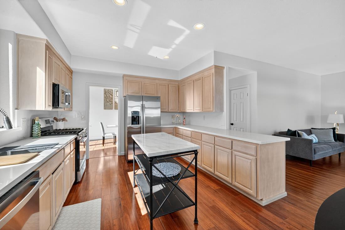 17671 Riverbend Road Salinas, CA 93908 - Photo 14 of 48 a kitchen with a table chairs refrigerator and cabinets