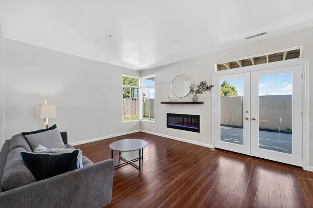 a living room with fireplace furniture and a wooden floor