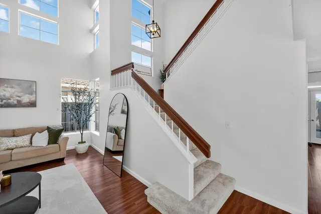 a view of entryway livingroom and hall with wooden floor