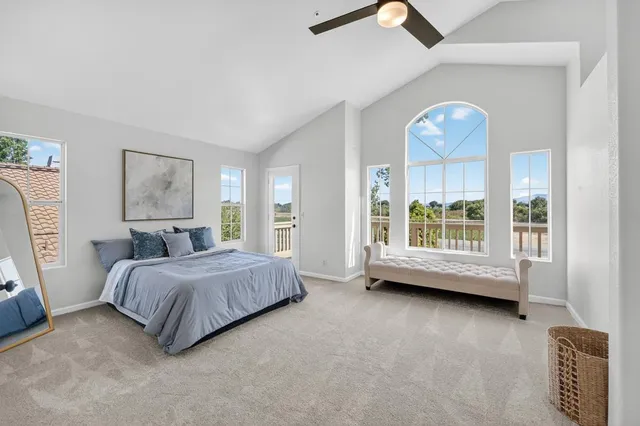 a bedroom with a bed and a painting on the wall