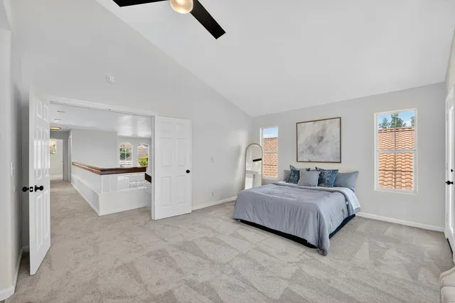 a bedroom with a bed and a large window