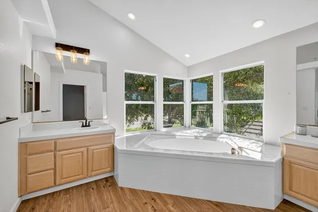 a bathroom with a double vanity sink mirror and shower
