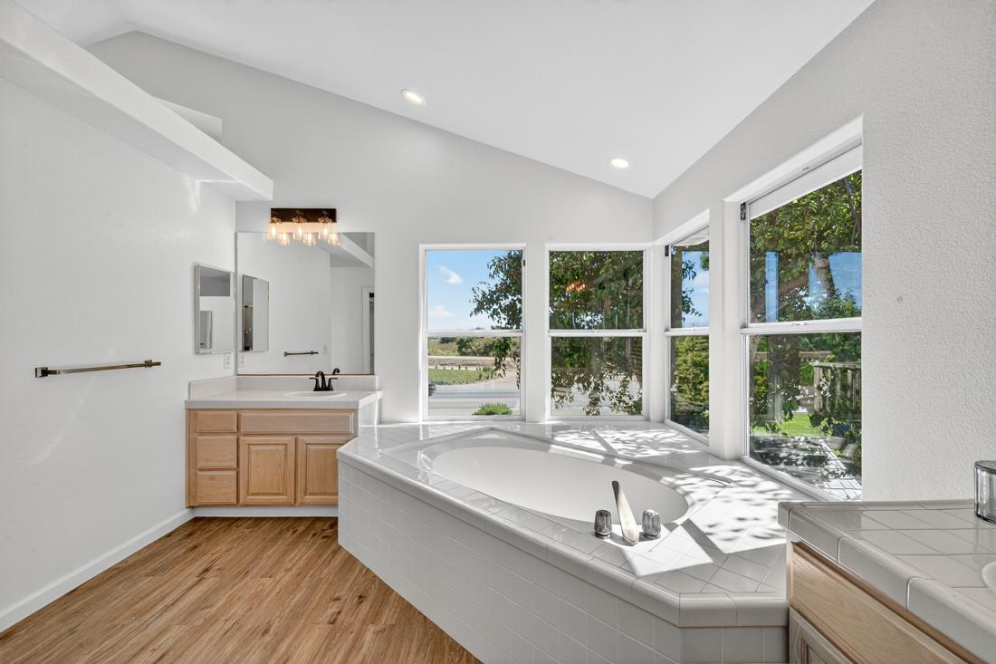 17671 Riverbend Road Salinas, CA 93908 - Photo 38 of 48 a large white kitchen with granite countertop a large window and a sink