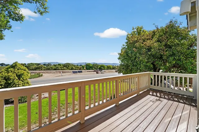 a view of a balcony with wooden floor