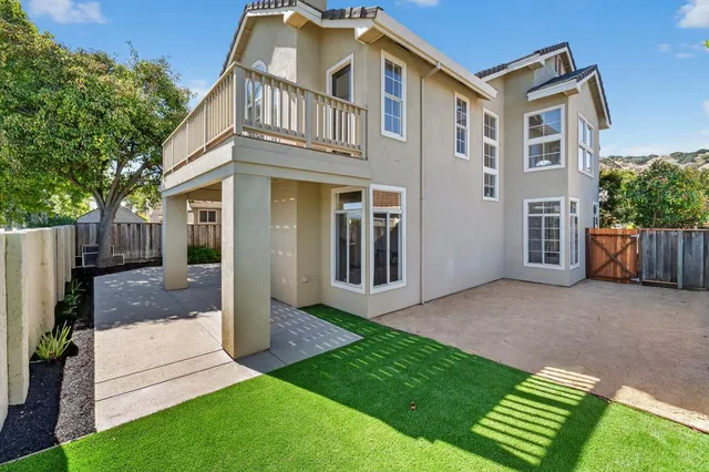a view of backyard with wooden fence