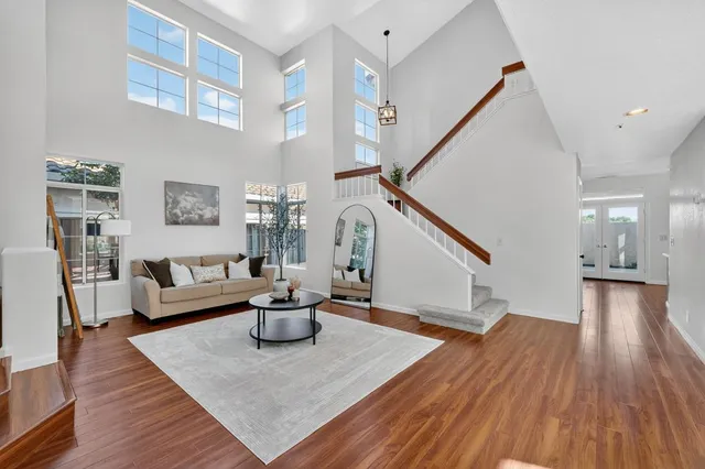a living room with furniture and a wooden floor