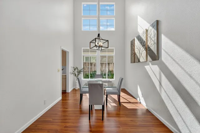 a view of a dining room with furniture wooden floor and a chandelier