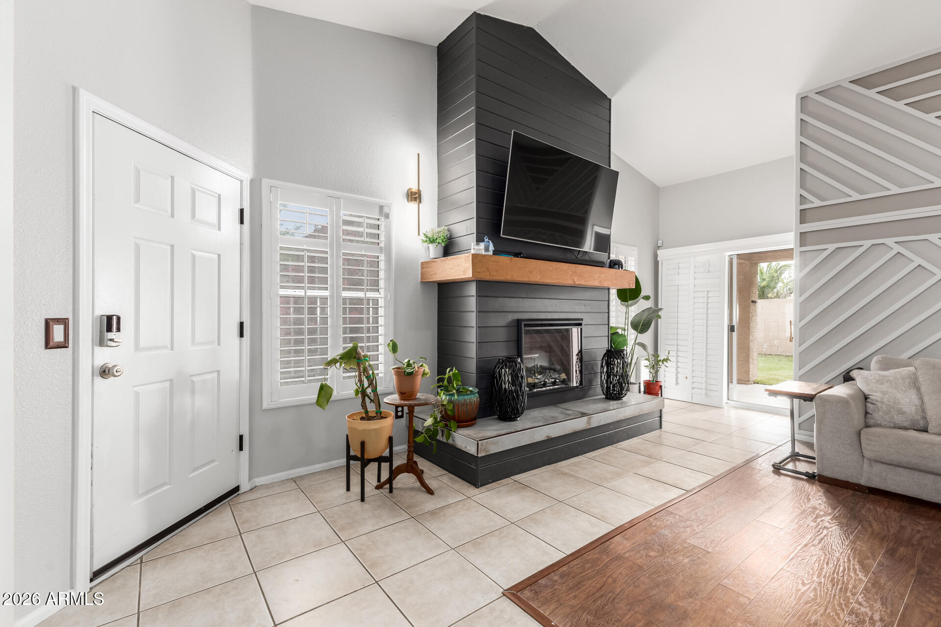 15587 West Rio Vista Lane Goodyear, AZ 85338 - Photo 11 of 36 a living room with furniture a flat screen tv and a fireplace