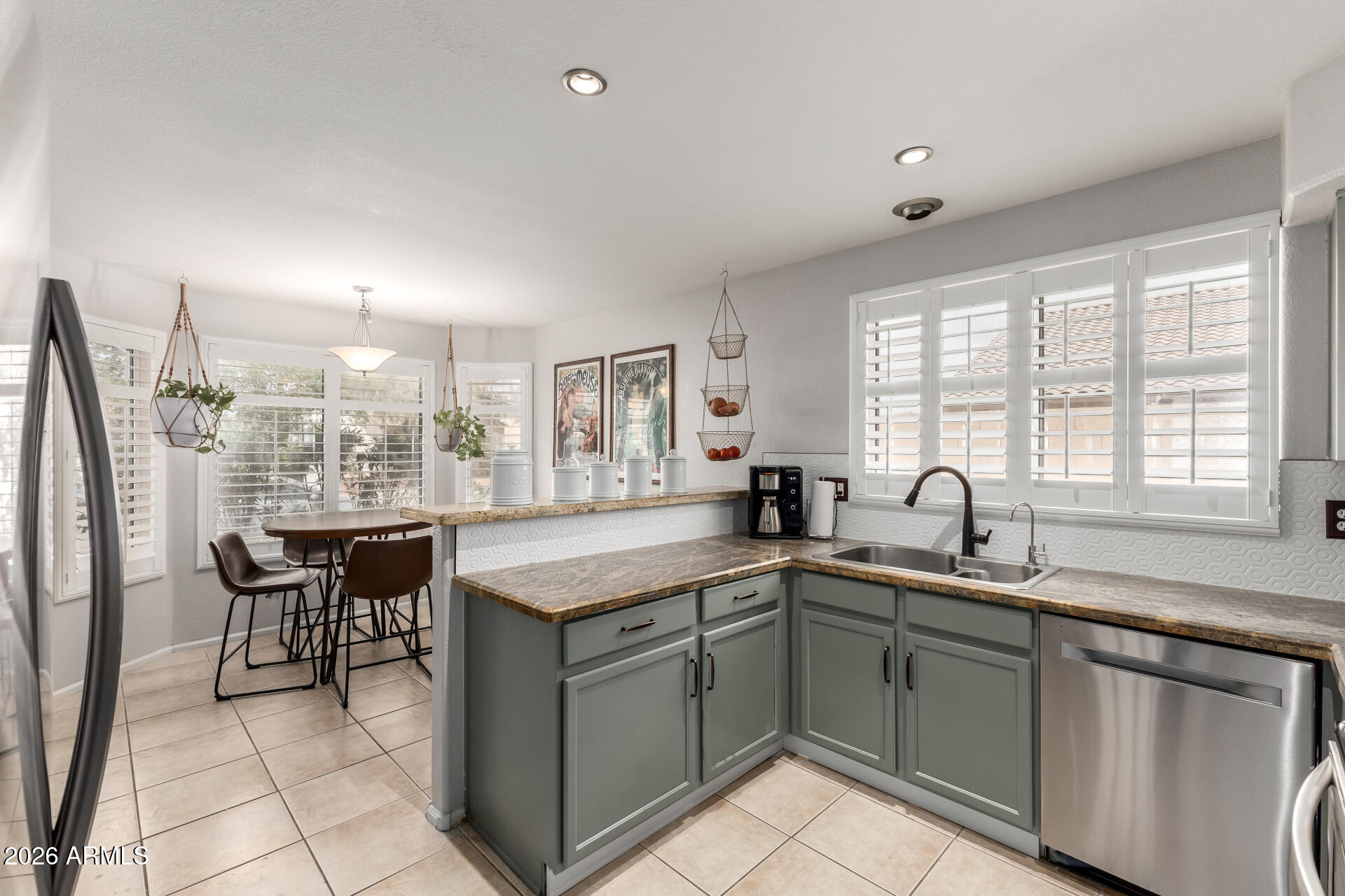 15587 West Rio Vista Lane Goodyear, AZ 85338 - Photo 13 of 36 a kitchen with a sink and cabinets