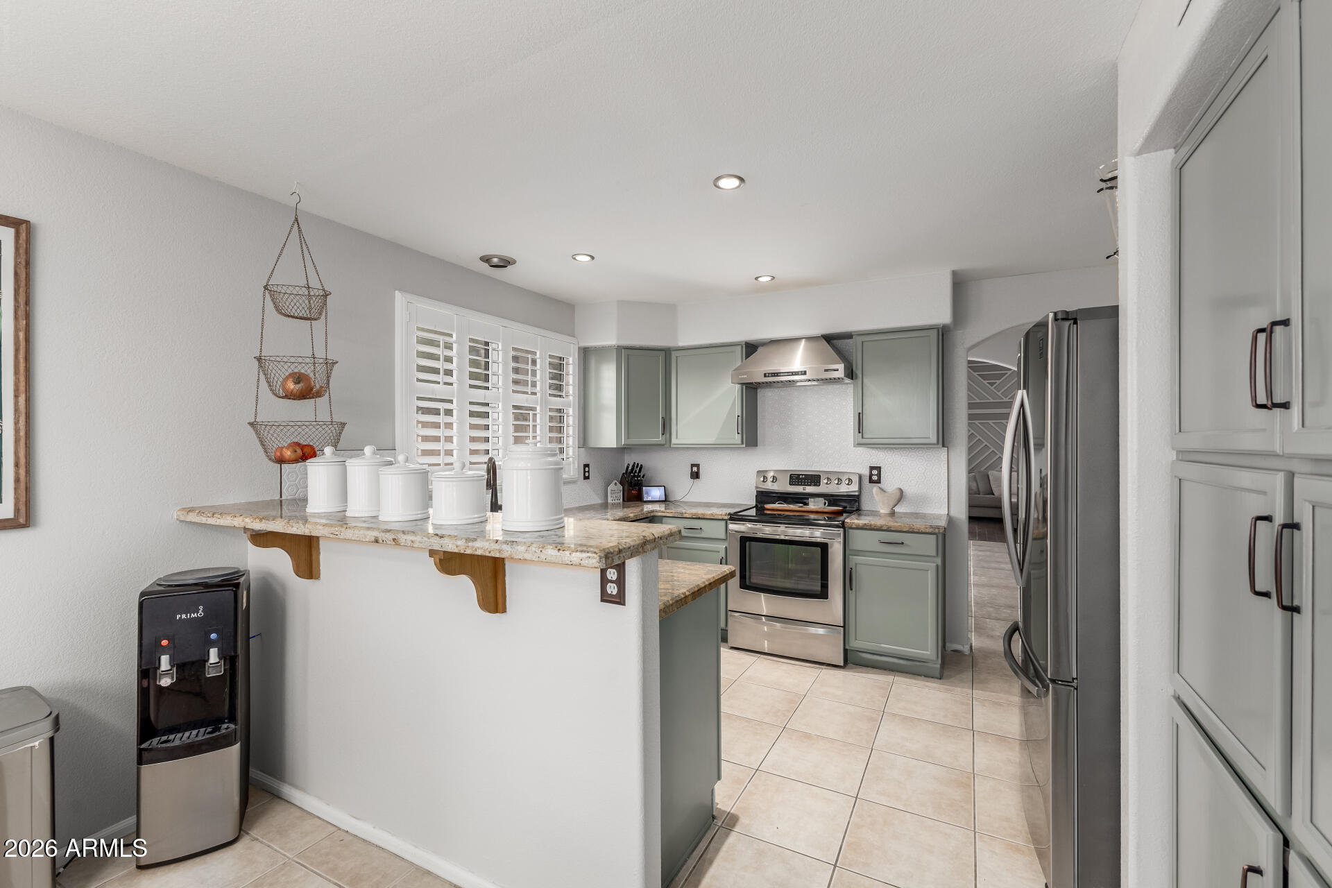 15587 West Rio Vista Lane Goodyear, AZ 85338 - Photo 15 of 36 a kitchen with a sink a stove and refrigerator