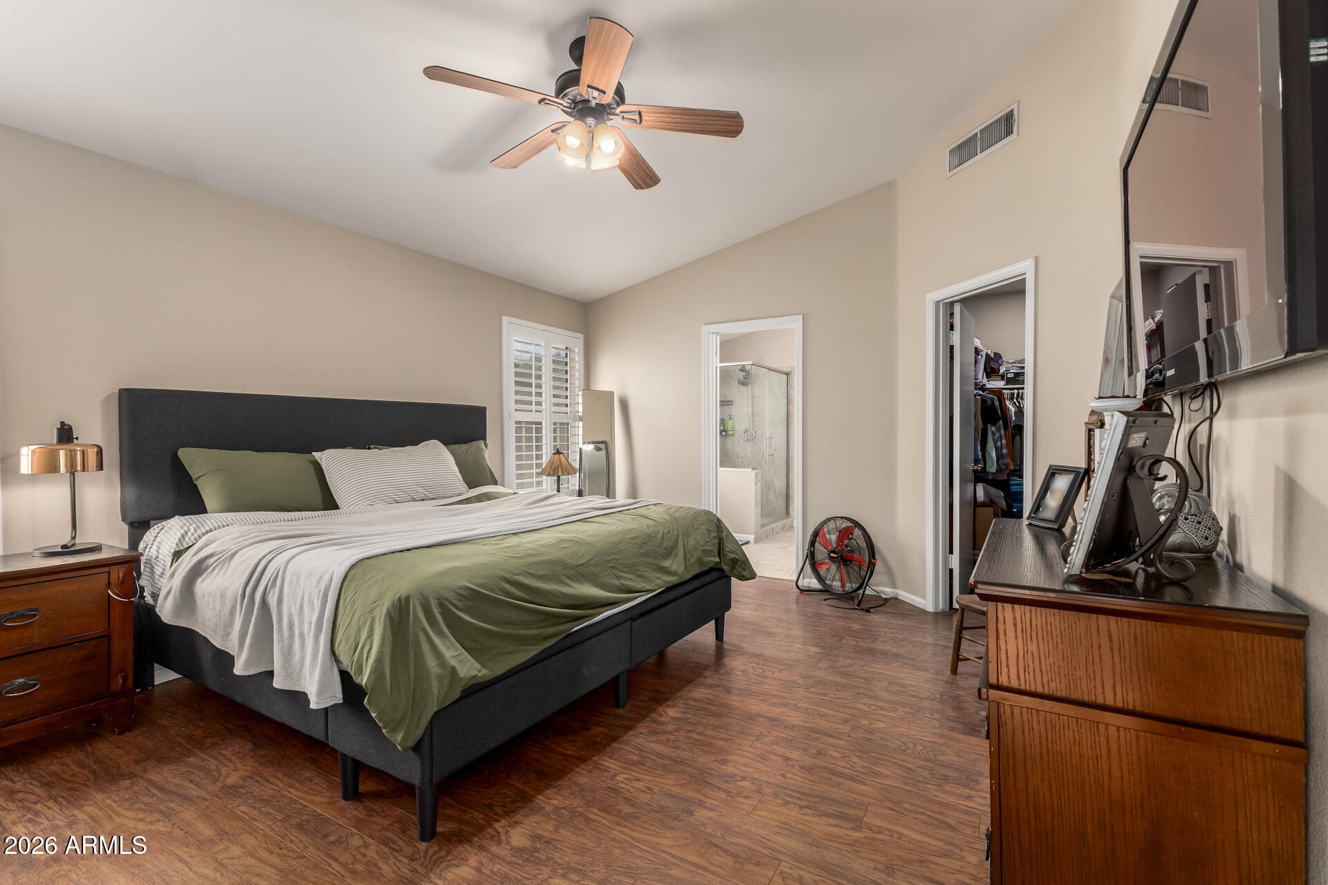 15587 West Rio Vista Lane Goodyear, AZ 85338 - Photo 19 of 36 a bedroom with a bed and a walk in closet