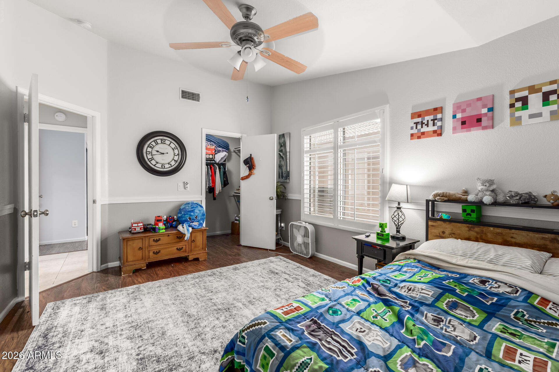 15587 West Rio Vista Lane Goodyear, AZ 85338 - Photo 27 of 36 a bedroom with a bed a clock and a window