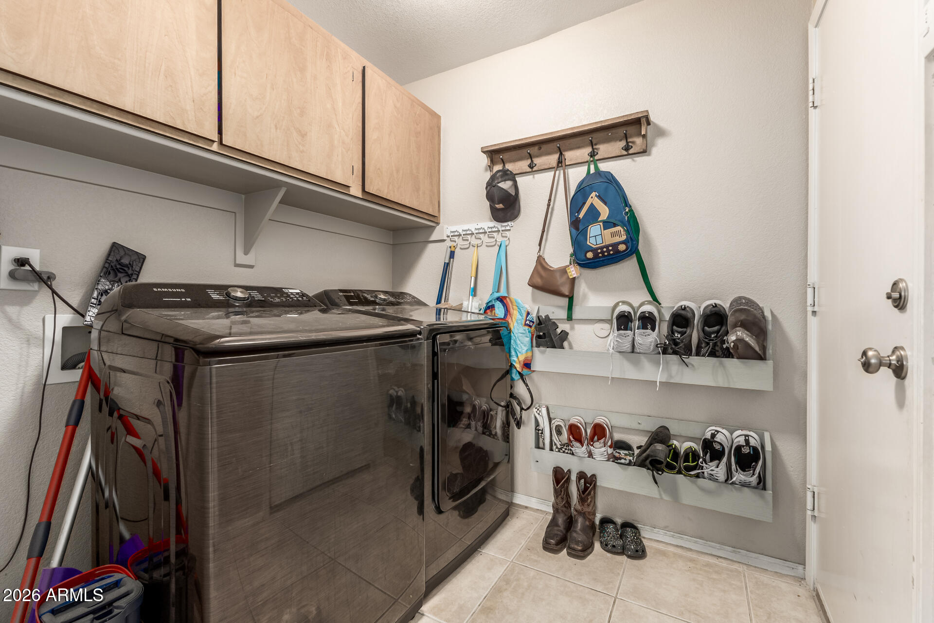 15587 West Rio Vista Lane Goodyear, AZ 85338 - Photo 29 of 36 a view of storage and utility room with washer and dryer