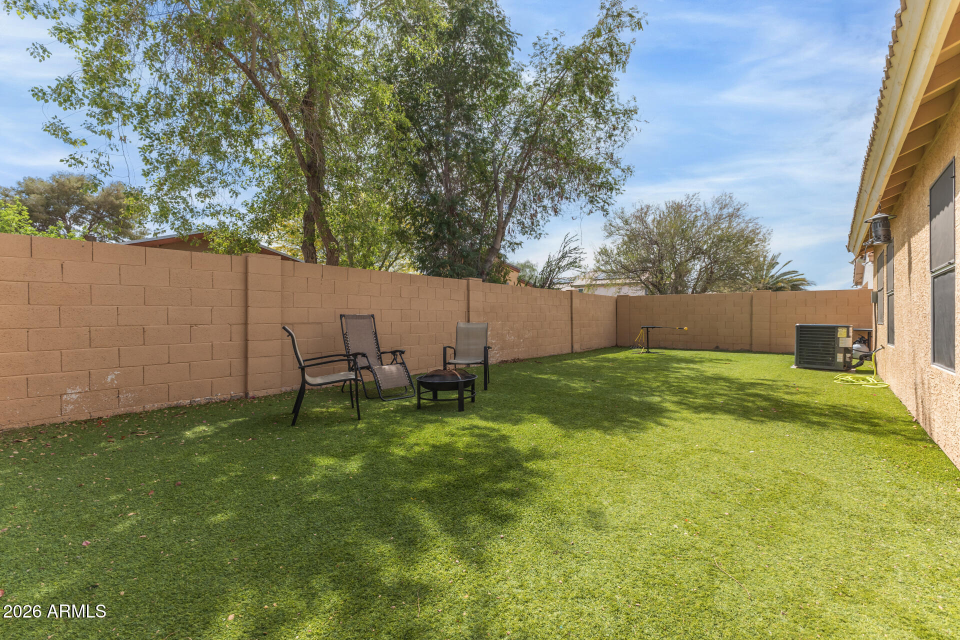 15587 West Rio Vista Lane Goodyear, AZ 85338 - Photo 32 of 36 a backyard of a house with table and chairs