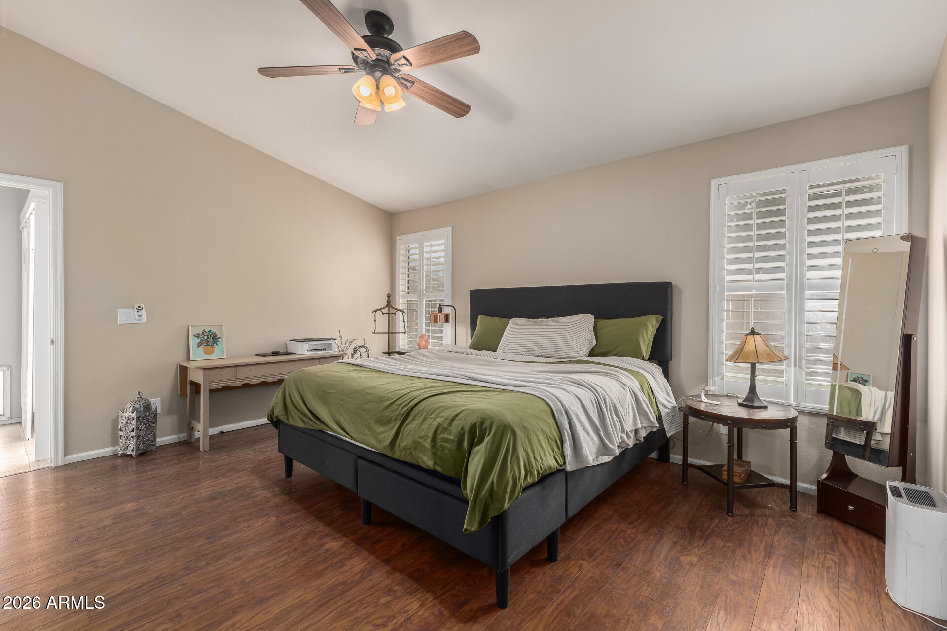 15587 West Rio Vista Lane Goodyear, AZ 85338 - Photo 6 of 36 a bedroom with a bed and a chandelier