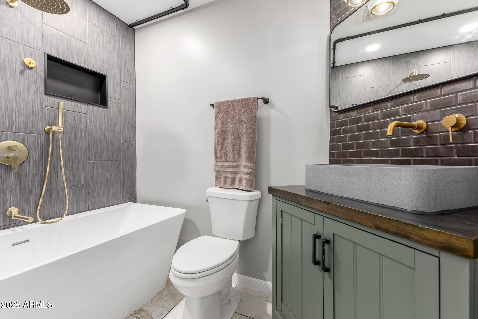 15587 West Rio Vista Lane Goodyear, AZ 85338 - Photo 7 of 36 a bathroom with a sink a toilet and shower