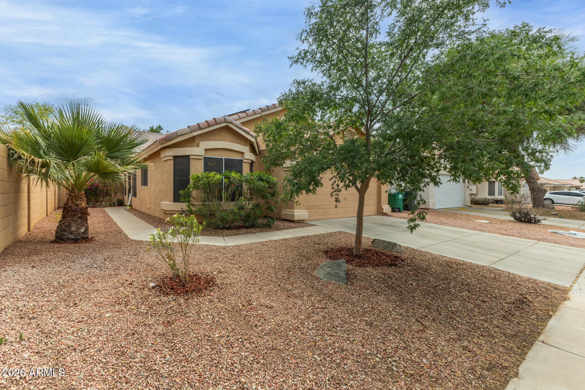 15587 West Rio Vista Lane Goodyear, AZ 85338 - Photo 8 of 36 a front view of a house with a yard and garage