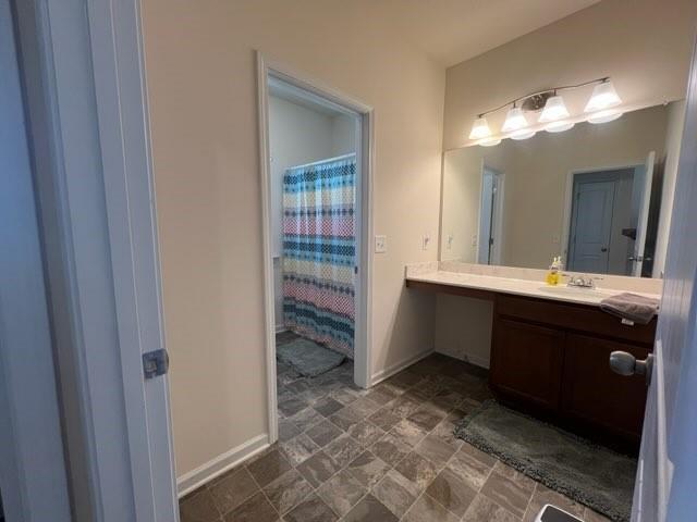 20 Pippin Place Northeast Rome, GA 30165 - Photo 23 of 25 Bathroom with vanity, stone finish flooring, and curtained shower