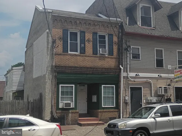 a front view of a house with parking space