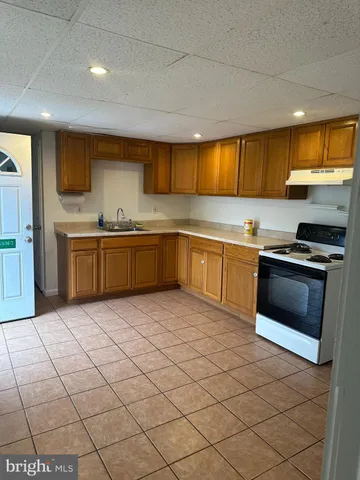 a kitchen with stainless steel appliances granite countertop a sink and a stove
